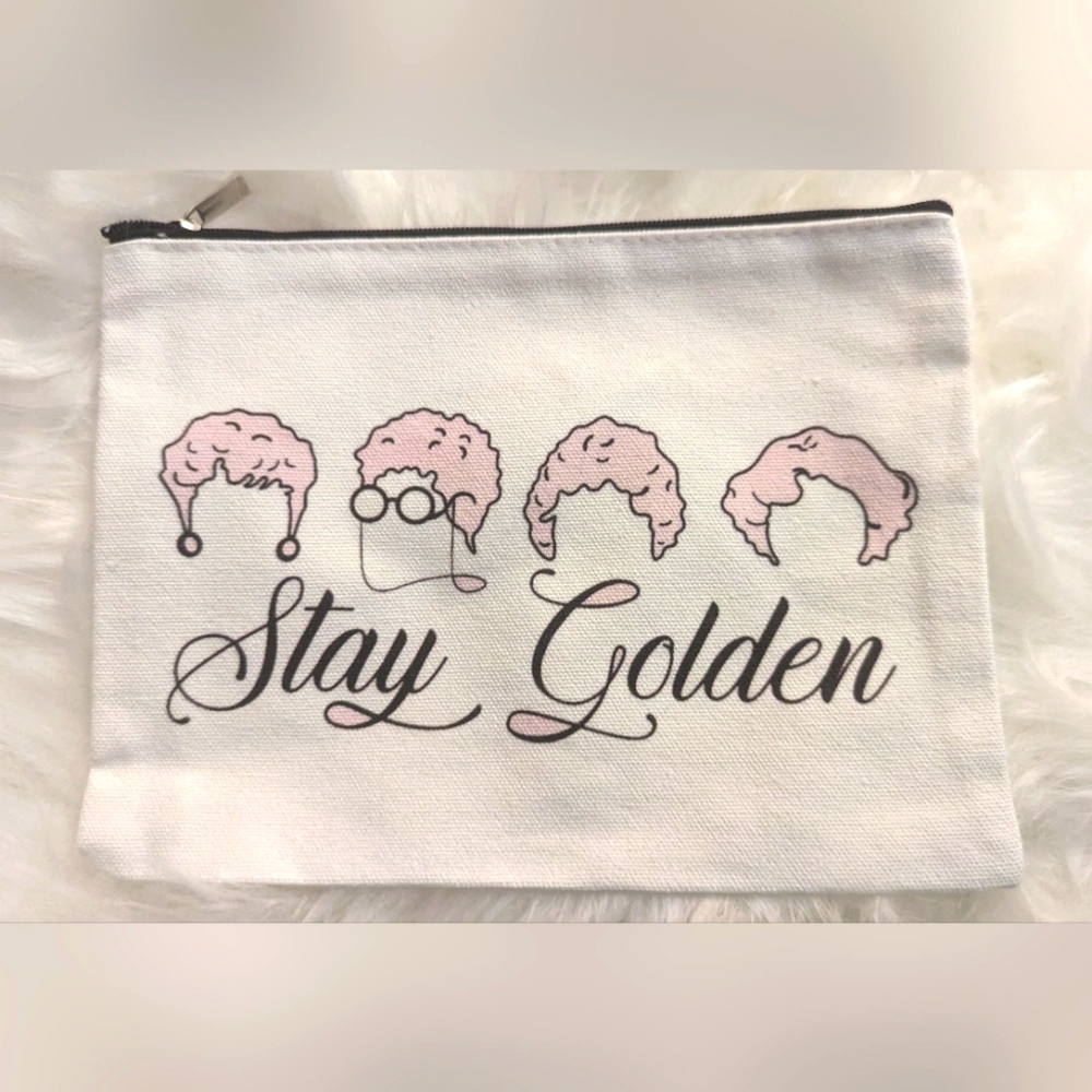 New white makeup bag black cursive Stay Golden writing, head/hair silhouettes in